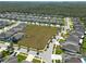Aerial view of a neighborhood with a large empty lot at 12512 Brick Cobblestone Dr, Riverview, FL 33579