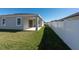Home's back exterior, showcasing a covered patio and fenced yard at 12512 Brick Cobblestone Dr, Riverview, FL 33579