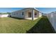 Large backyard with grassy area and covered patio at 12512 Brick Cobblestone Dr, Riverview, FL 33579