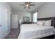 Main bedroom with striped bedding and ceiling fan at 12512 Brick Cobblestone Dr, Riverview, FL 33579