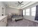 Main bedroom with ceiling fan and en-suite bathroom access at 12512 Brick Cobblestone Dr, Riverview, FL 33579