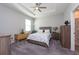 Cozy bedroom with carpeted floor, a dresser, and a queen-sized bed at 12512 Brick Cobblestone Dr, Riverview, FL 33579