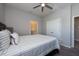Main bedroom with striped bedding and ceiling fan at 12512 Brick Cobblestone Dr, Riverview, FL 33579