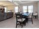 Dining area with a six-seat table and view of the living room at 12512 Brick Cobblestone Dr, Riverview, FL 33579