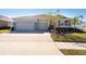 Two-story house with a three-car garage and well maintained landscaping at 12512 Brick Cobblestone Dr, Riverview, FL 33579