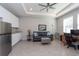 Versatile living area with a sofa, home office setup, and built-in cabinetry at 12512 Brick Cobblestone Dr, Riverview, FL 33579