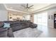 Bright and airy living room with sectional sofa and access to patio at 12512 Brick Cobblestone Dr, Riverview, FL 33579