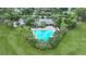 Aerial view showing community pool and surrounding green space at 13685 Newbridge St, Spring Hill, FL 34609