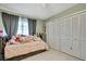 Bright bedroom with twin bed, ample closet space, and ceiling fan at 14190 Fennsbury Dr, Tampa, FL 33624