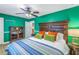 Spacious bedroom with a green accent wall and wood flooring at 1517 10Th N Ave, St Petersburg, FL 33705