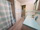 Updated bathroom with blue vanity and walk-in shower at 2331 Belleair Rd # 611, Clearwater, FL 33764