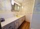 Retro bathroom with yellow vanity and tiled walls at 2331 Belleair Rd # 611, Clearwater, FL 33764