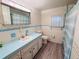 Clean bathroom with light blue vanity and updated flooring at 2331 Belleair Rd # 611, Clearwater, FL 33764