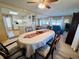 Dining room with oval table, six chairs, and a view into the kitchen at 2331 Belleair Rd # 611, Clearwater, FL 33764