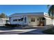 Charming single-story home featuring well-maintained landscaping and a convenient covered parking area at 2331 Belleair Rd # 611, Clearwater, FL 33764