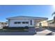 Single-wide manufactured home with carport and well-manicured landscaping at 2331 Belleair Rd # 611, Clearwater, FL 33764