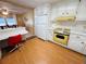 White kitchen cabinets and yellow appliances with a breakfast bar at 2331 Belleair Rd # 611, Clearwater, FL 33764
