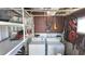 Well-lit laundry room with washer, dryer, and ample storage shelving at 2331 Belleair Rd # 611, Clearwater, FL 33764