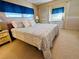 Spacious main bedroom with a comfortable king-size bed and ensuite bathroom at 2331 Belleair Rd # 611, Clearwater, FL 33764