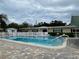 Community pool with a refreshing, clear blue water, surrounded by a fence and brick paving at 2331 Belleair Rd # 611, Clearwater, FL 33764