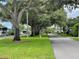 A serene street lined with mature trees and green lawns in a peaceful residential community at 2331 Belleair Rd # 611, Clearwater, FL 33764