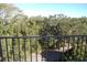 Balcony view overlooking tree-lined street and neighborhood at 2699 Seville Blvd # 605, Clearwater, FL 33764