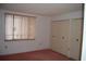 Bright bedroom with window, carpet, and double closets at 2699 Seville Blvd # 605, Clearwater, FL 33764