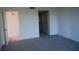 Bedroom with neutral carpeting and access to hallway at 2699 Seville Blvd # 605, Clearwater, FL 33764