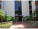 Condo building entrance with landscaping and brick pathway at 2699 Seville Blvd # 605, Clearwater, FL 33764