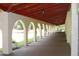 Long covered walkway with arches, offering a serene path through the community at 2699 Seville Blvd # 605, Clearwater, FL 33764
