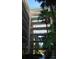 Multi-level building with balconies and tropical landscaping at 2699 Seville Blvd # 605, Clearwater, FL 33764
