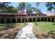 Spanish-style building with a walkway and manicured lawn at 2699 Seville Blvd # 605, Clearwater, FL 33764