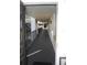 Interior hallway with exit sign and balcony view at 2699 Seville Blvd # 605, Clearwater, FL 33764