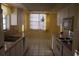 Bright kitchen features white cabinets, tiled countertops, and built-in appliances at 2699 Seville Blvd # 605, Clearwater, FL 33764