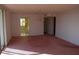Spacious living room with pink carpet and chandelier at 2699 Seville Blvd # 605, Clearwater, FL 33764