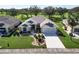 Single-story house with landscaped yard, driveway, and two-car garage. Located in a residential neighborhood at 334 Caloosa Palms Ct, Sun City Center, FL 33573