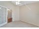 Bright bedroom with carpeted floor, french doors, and ceiling fan at 334 Caloosa Palms Ct, Sun City Center, FL 33573