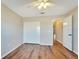 Bedroom with wood-look floors and double door closet at 334 Caloosa Palms Ct, Sun City Center, FL 33573