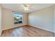 Spacious bedroom featuring wood-look flooring and a large window at 334 Caloosa Palms Ct, Sun City Center, FL 33573