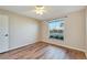 Well-lit bedroom with wood-look floors and window blinds at 334 Caloosa Palms Ct, Sun City Center, FL 33573