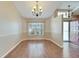 Dining room with hardwood floors, chandelier, and window at 334 Caloosa Palms Ct, Sun City Center, FL 33573