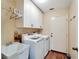 Laundry room with washer, dryer, and ample storage at 334 Caloosa Palms Ct, Sun City Center, FL 33573