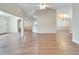 Open floor plan living room with hardwood floors, and kitchen views at 334 Caloosa Palms Ct, Sun City Center, FL 33573