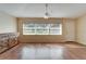 Bright living room with hardwood floors and large window offering a view at 334 Caloosa Palms Ct, Sun City Center, FL 33573