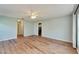 Open living room with wood-look floors and access to kitchen at 334 Caloosa Palms Ct, Sun City Center, FL 33573