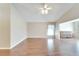 Open living room with wood-look floors and ceiling fan at 334 Caloosa Palms Ct, Sun City Center, FL 33573