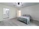 Bedroom with ensuite bathroom access and walk-in closet space, featuring a ceiling fan and modern flooring at 3873 21St N Ave, St Petersburg, FL 33713