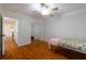 Bedroom boasts hardwood floors, ceiling fan, closet and access to hallway at 3873 21St N Ave, St Petersburg, FL 33713