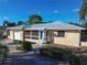 Inviting yellow house with screened porch, landscaped yard, and attached garage at 3873 21St N Ave, St Petersburg, FL 33713