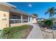 Landscaped walkway leading to a charming light blue door and screened porch at 3873 21St N Ave, St Petersburg, FL 33713